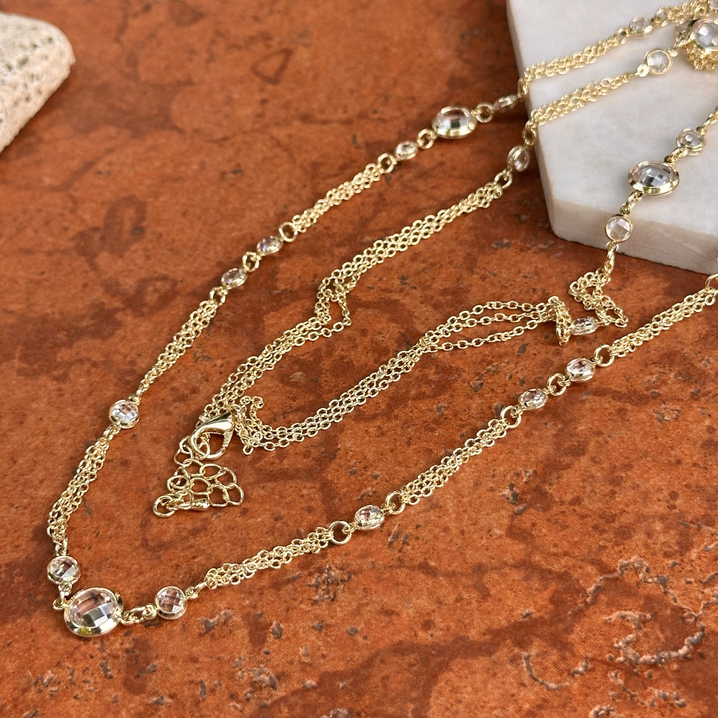 Yellow Gold-Plated Round Checkerboard Cubic Zirconia Three-Strand Necklace