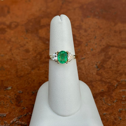 14KT Yellow Gold Oval Emerald + Trillion Diamond Ring