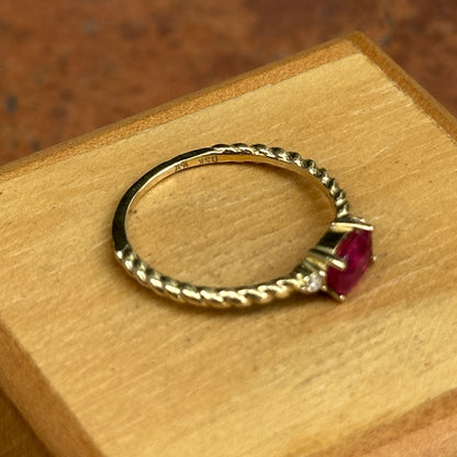 10KT Yellow Gold Oval Ruby + Round Diamond Twisted Design Ring