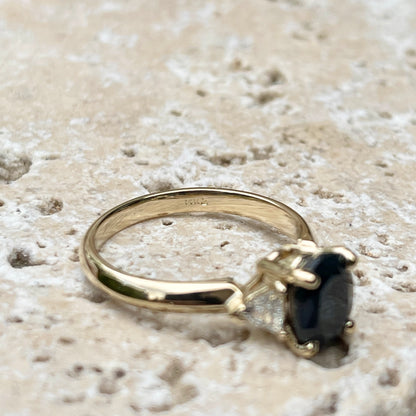 14KT Yellow Gold Oval .95 CT Blue Sapphire + Trillion Diamond Accent Ring